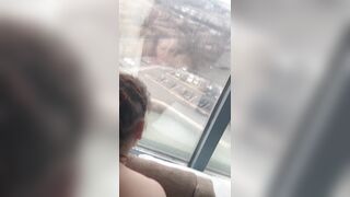 Giving backshots while looking out of 12th story hotel