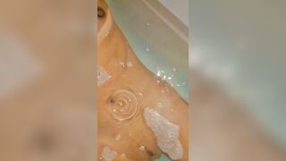 asian petite girl being naughty , fingering her pussy while having a bath
