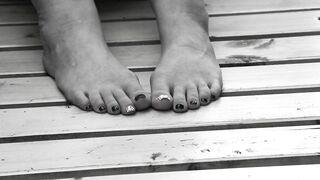 Women's feet on a park bench.